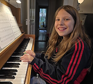 Klara spielt motiviert ein Stück von den Beatles während des Klavierunterrichts Bern bei Klavierlehrer Kurt Wieland.